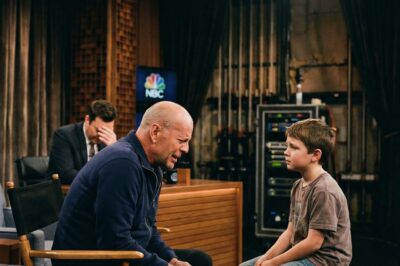 A Phoenix, Arizona boy stepped onto The Tonight Show stage and whispered three words that paralyzed Bruce Willis. Jimmy Fallon’s laughter died instantly as the cameras captured a raw, heartbreaking moment that changed everyone in Studio 6B forever.