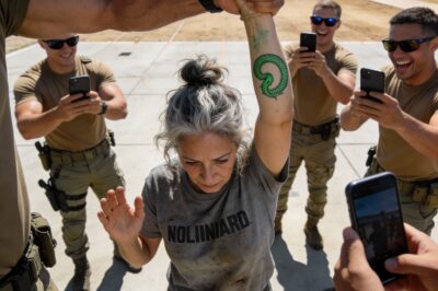 My hand was shaking so badly I could hear the mop handle rattling against the bucket. I tried to make myself small, to disappear into the gray concrete walls like I always do. But he wouldn’t let me. “Look at this,” the Captain sneered, yanking my sleeve up to expose the faded ink on my forearm. “Grandma here thinks she’s a warrior.” The cameras came out instantly. Flashlights blinded me. They wanted a viral moment? They wanted to expose a fraud? They had no idea that the “fraud” trembling before them was the only reason they were standing there today.