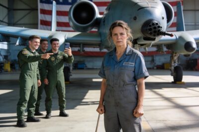 My hands were shaking, not from fear, but from a rage I hadn’t felt in years. He kicked the bucket of dirty water over my sneakers, the gray liquid soaking into my socks. “Oops,” he laughed, high-fiving the Lieutenant next to him. “Clean that up too, sweetheart. It’s what you’re paid for, right?” I looked down at the puddle, seeing my own reflection—a tired, 45-year-old woman in a stained blue jumpsuit. He saw a janitor. He didn’t see the scars on my arms from the crash in Afghanistan. He didn’t know that the machine he was leaning against was the only thing I loved more than life itself. I gripped the mop handle until my knuckles turned white.