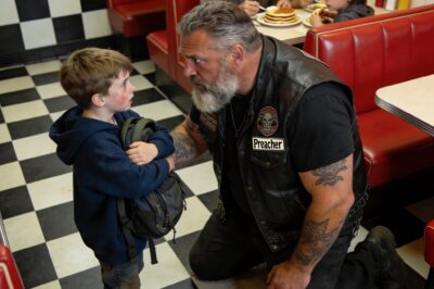 “The waitress with the cross around her neck told him to go pray for forgiveness. The businessman checked his watch. They pushed him right to the edge of the cliff. But when he looked at me—scarred, tattooed, and dangerous—he didn’t see a thug. He saw the only option left. And I knew, the second he stopped trembling, that I wasn’t leaving this diner without him.”